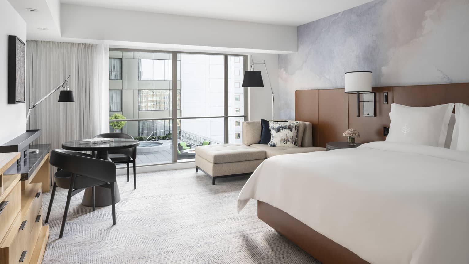 A fire pit and hot tub can be seen out the window of the Superior King Room