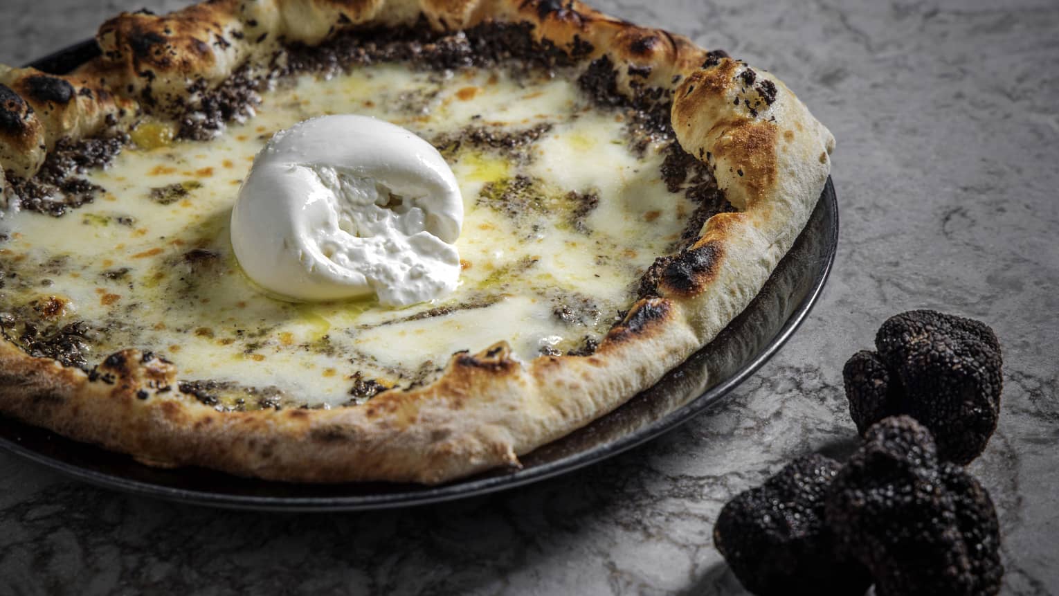 Truffle pizza with a ball of burrata in the middle