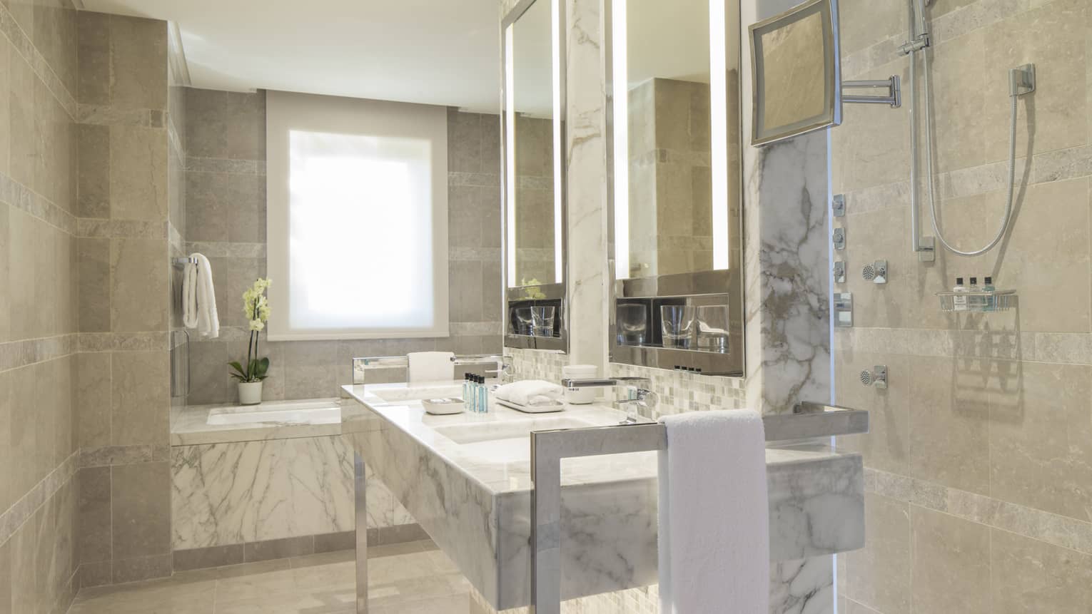 Executive Suite full white and grey marble bathroom, vanity with double sink, tub