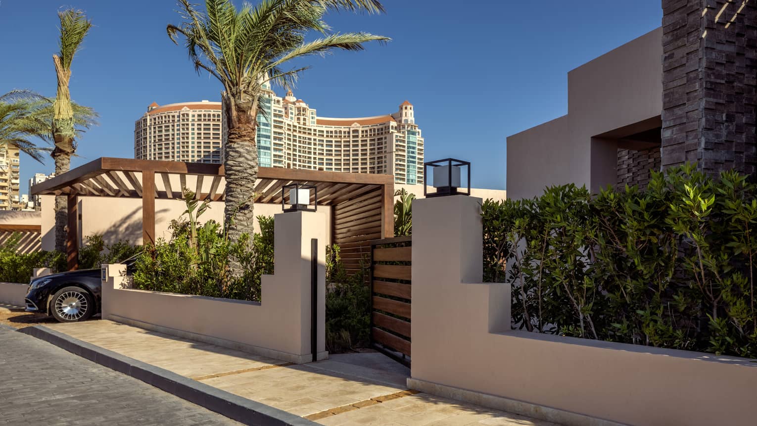 Main gate of One-Bedroom Beach Villa flanked by palm trees