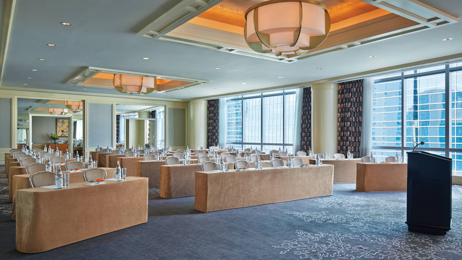 Rows of meeting tables in bright function room