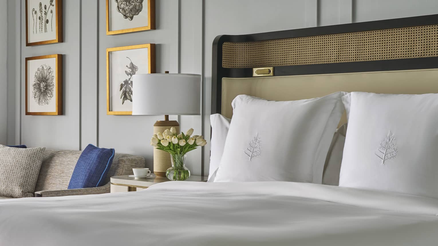 King bed with white sheets and Four Seasons-embroidered shams