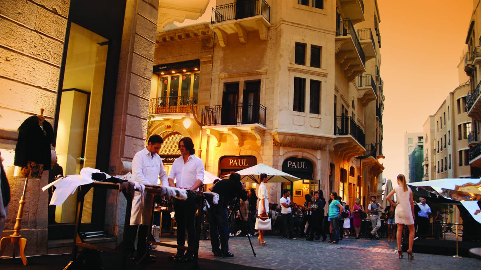 People along Beirut street by cafes. storefronts at sunset 