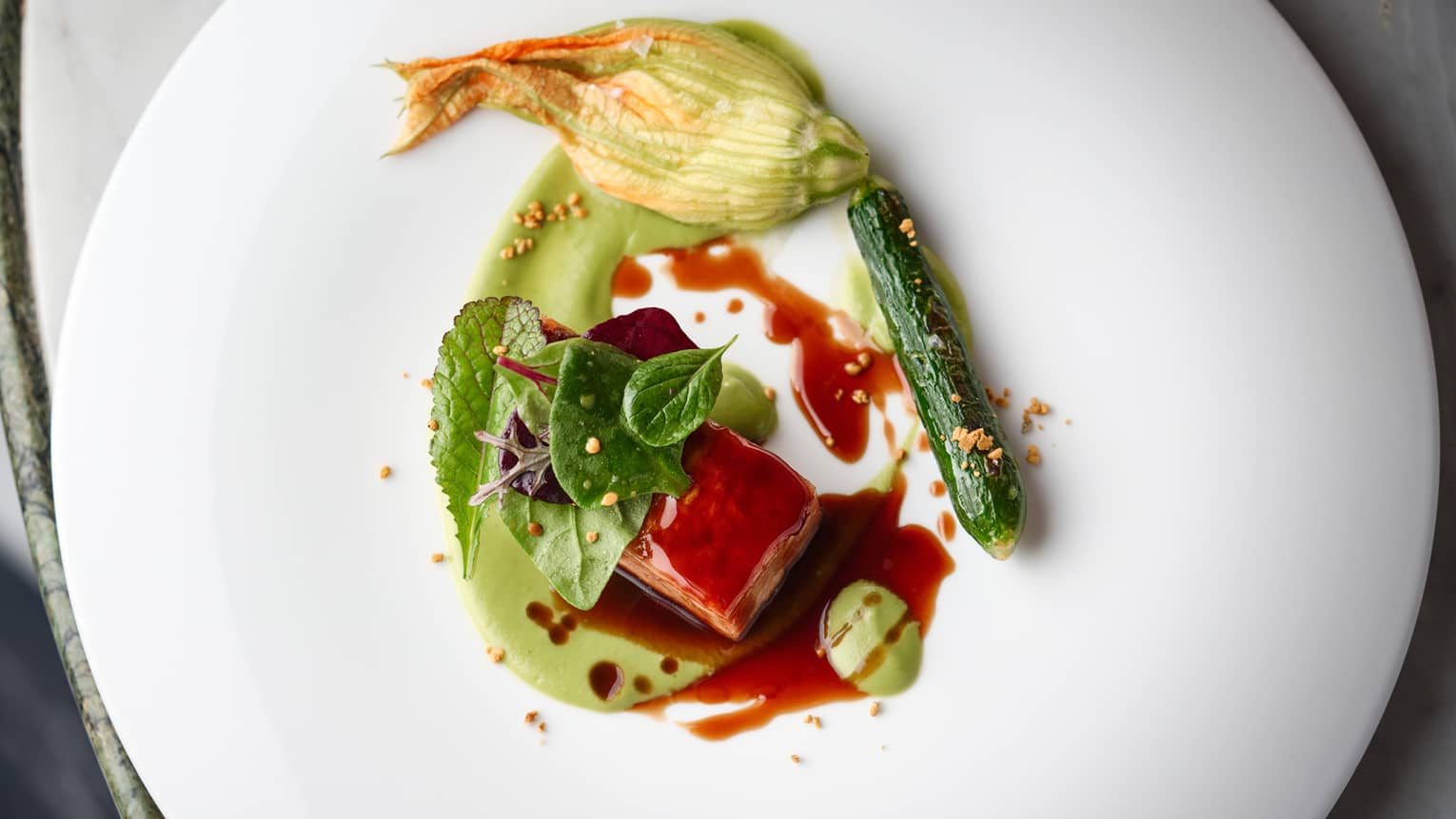 Lamb and zucchini with a red sauce.