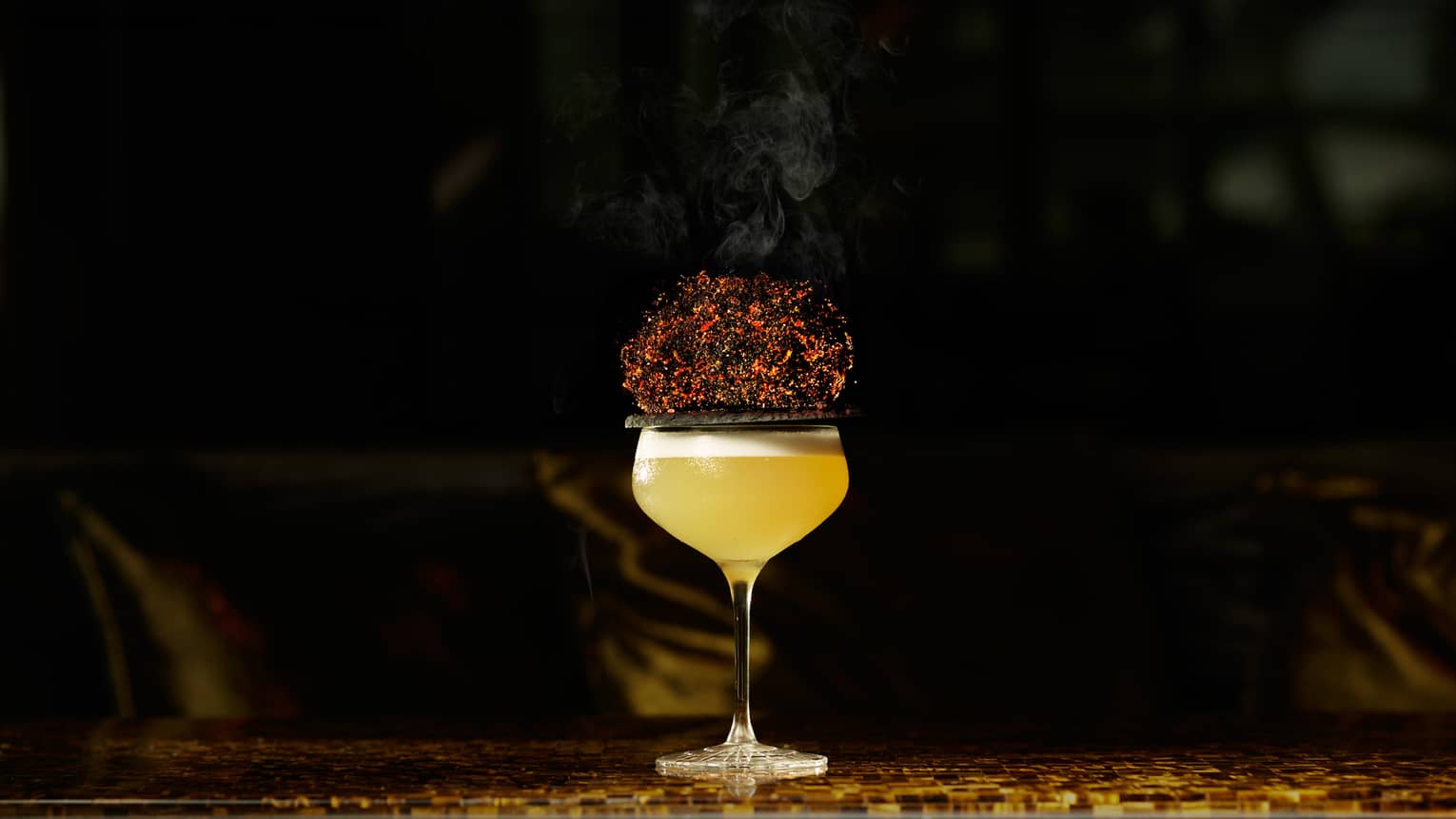 Yellow cocktail in stemmed glass