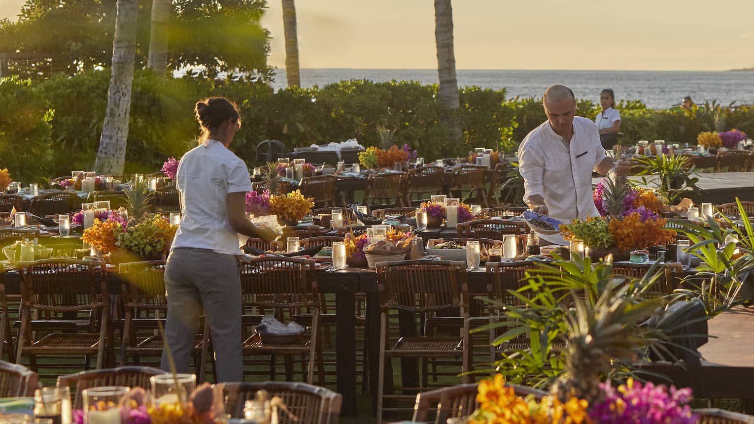 Four Seasons staff setting tables outside of Four Seasons Hawaii, Oahu at Ko Olinaat a Luau Dinner