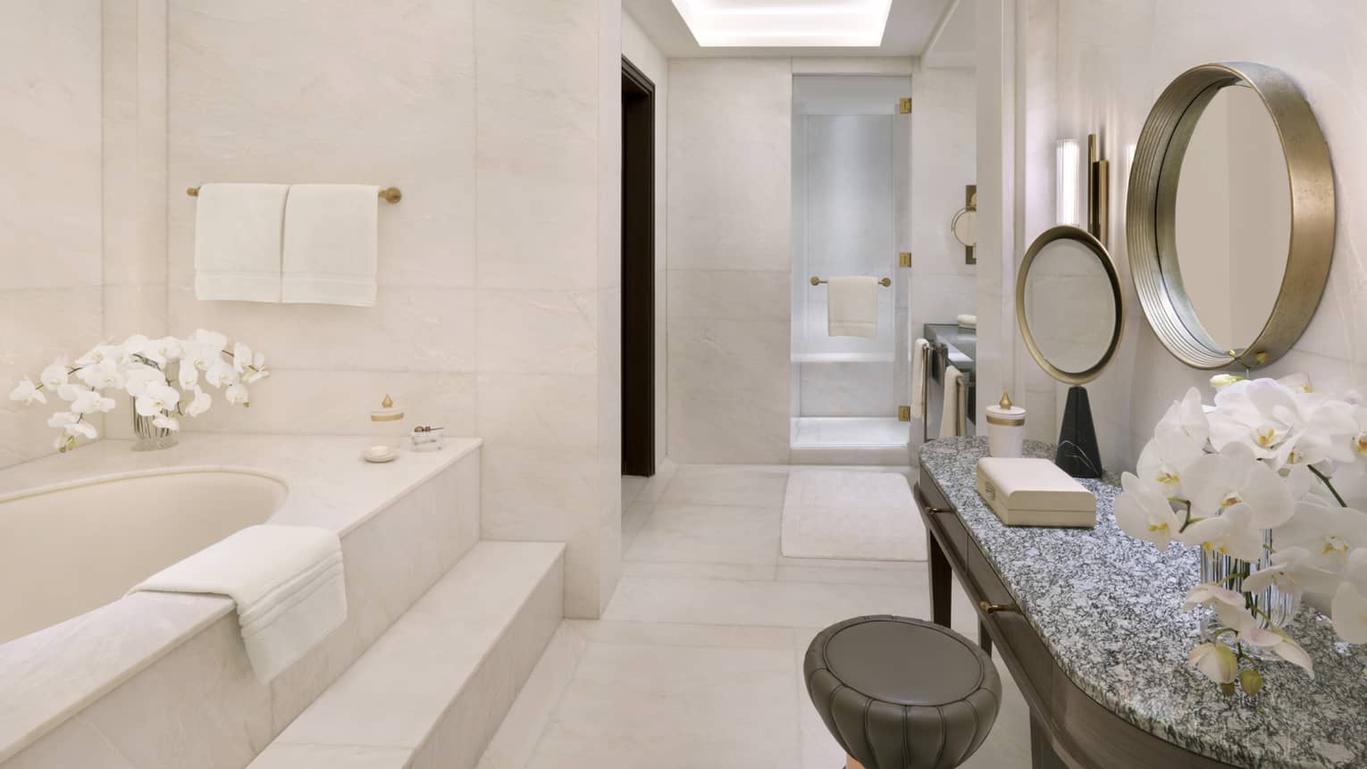 Large marble bathroom with tub, make-up vanity and walk-in shower