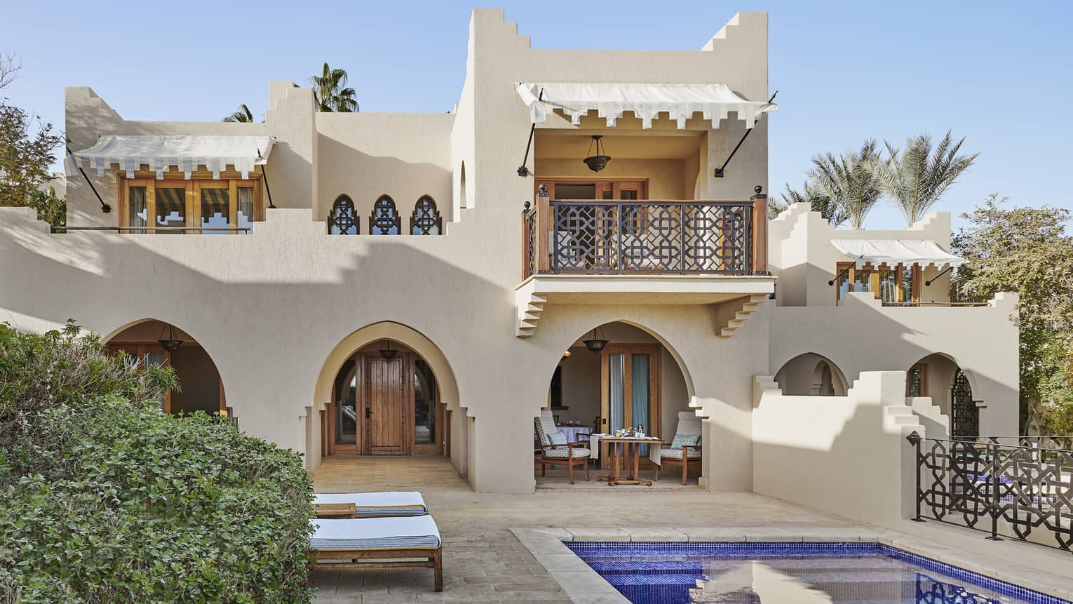 Villa with traditional Egyptian detailing, and pool with sun loungers