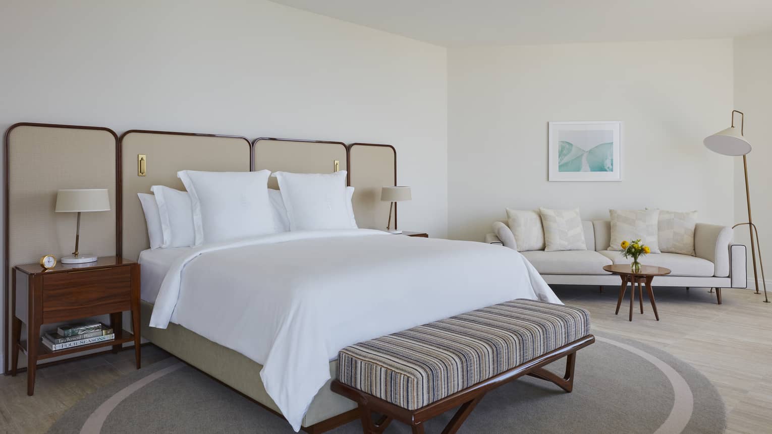 Bedroom with king bed, bench and sofa
