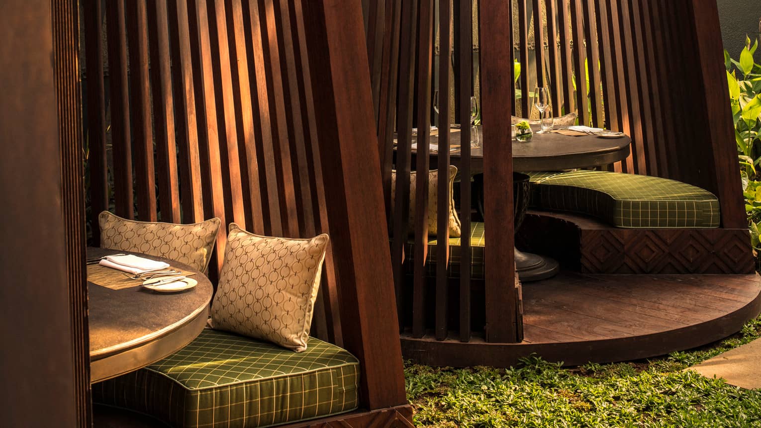Close-up of Palm Court terrace wood cabanas with green cushions