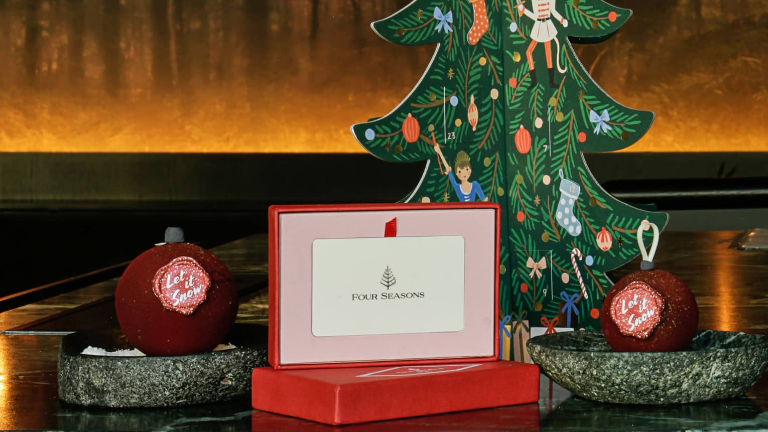 A gift card next to a small paper Christmas tree.