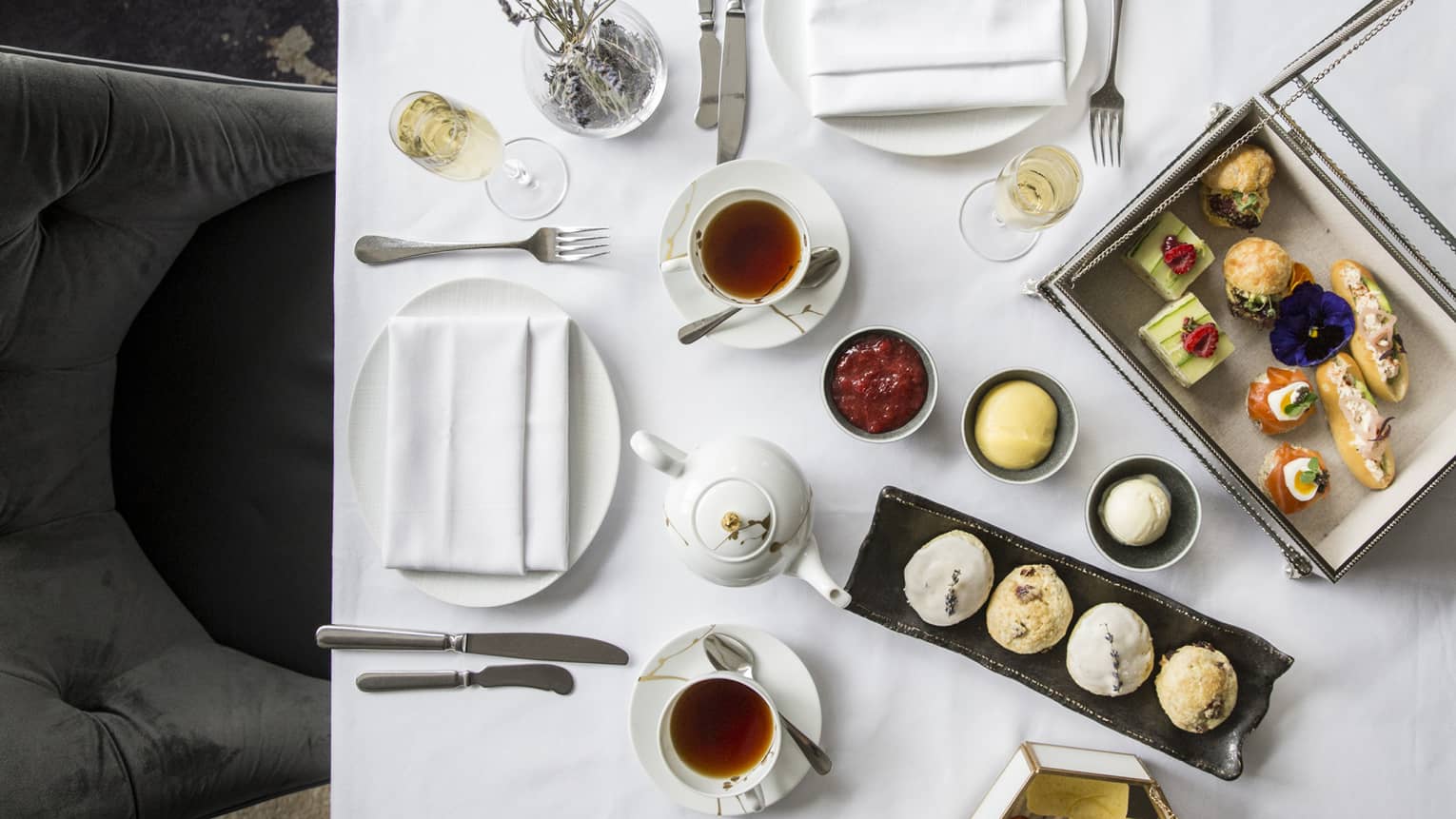 Aerial view of elegant afternoon tea display, complete with finger foods and condiments