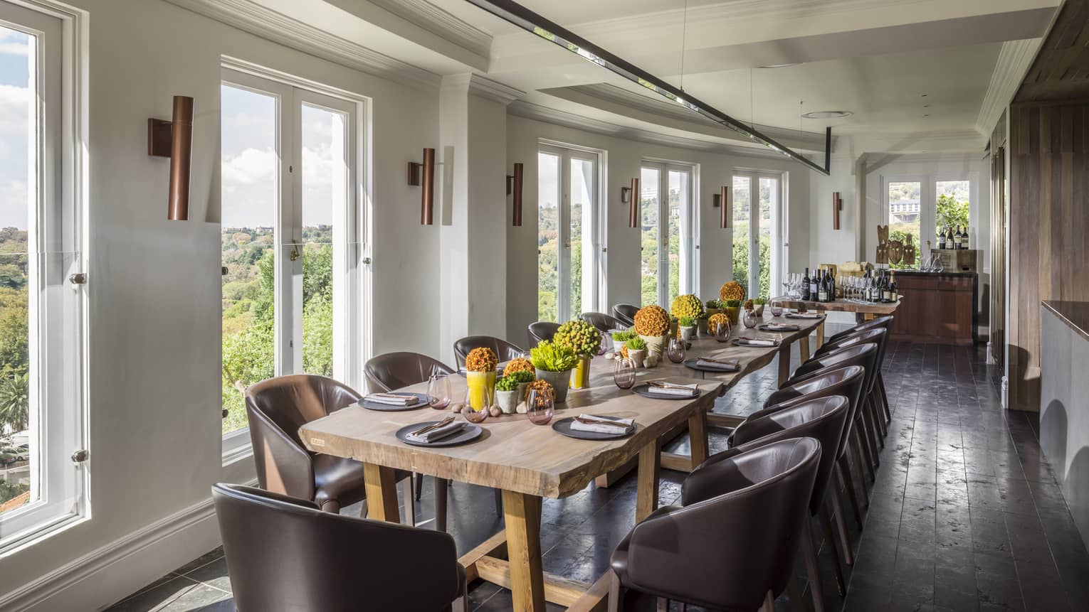 Long dining table with flowers in bright Cellar Door Show Kitchen 