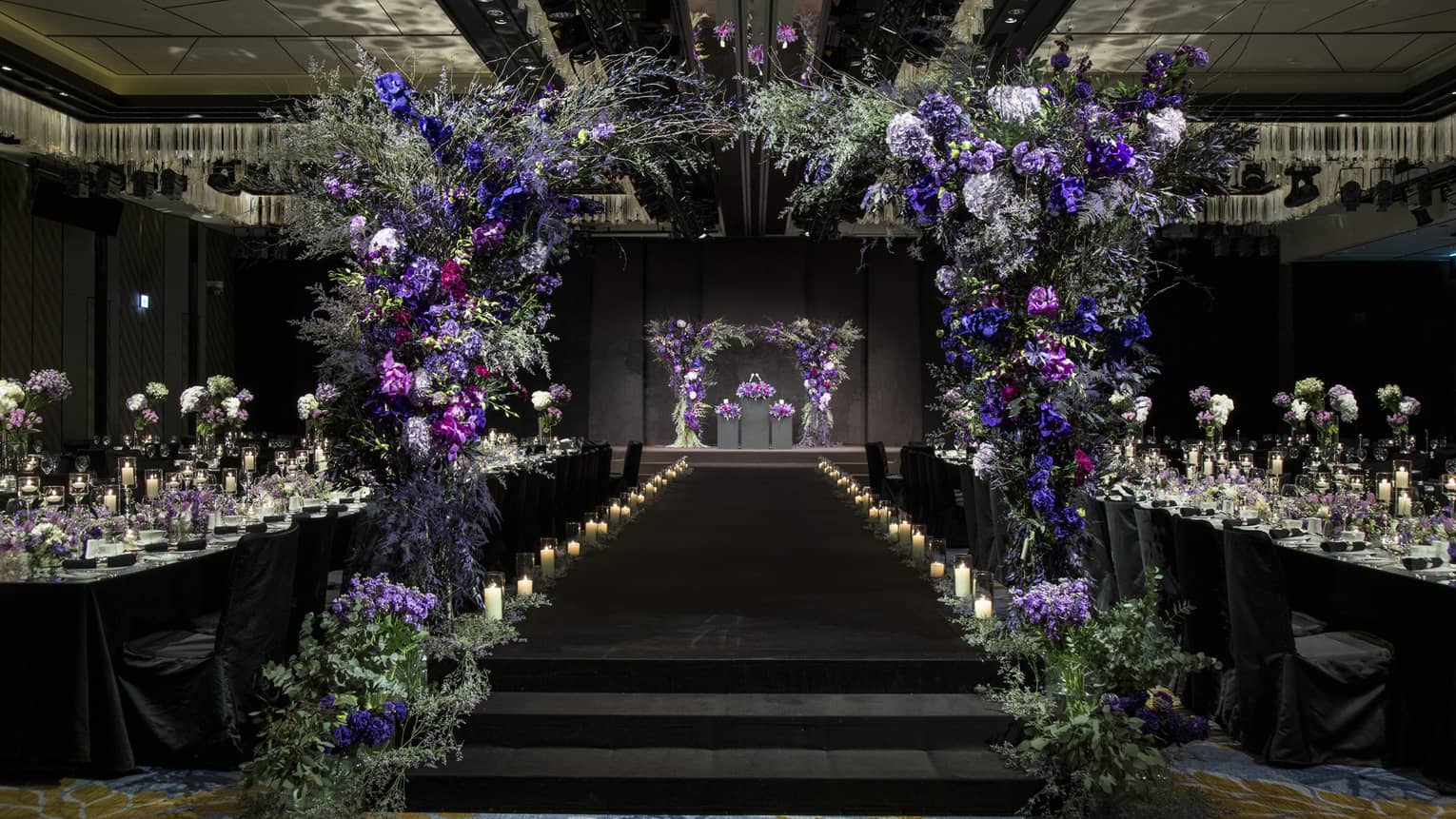 Glamourous Grand Ballroom II with candles and archway made of purple flowers
