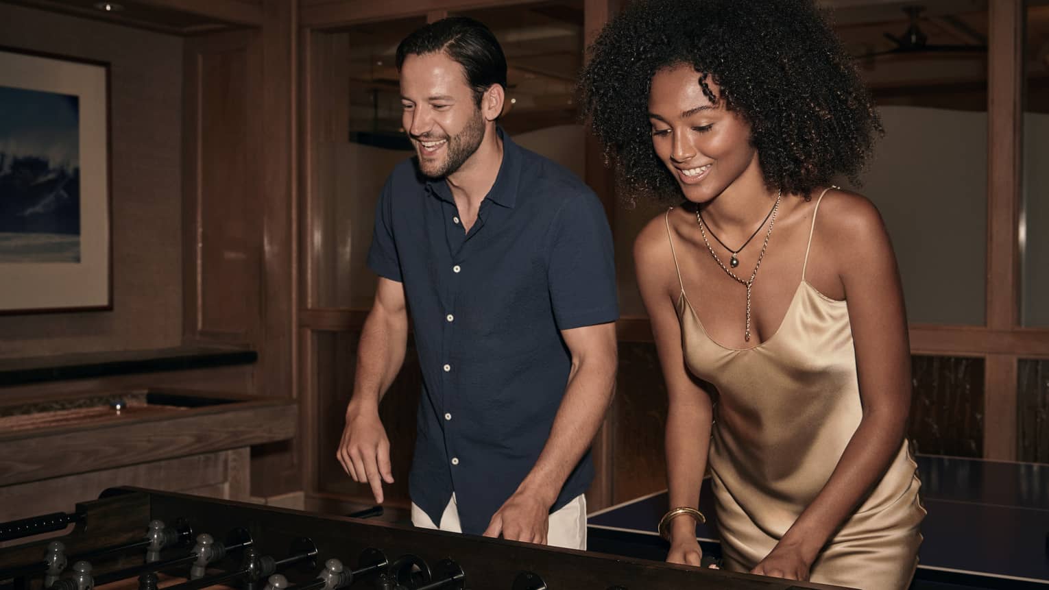 Man and woman play foosball