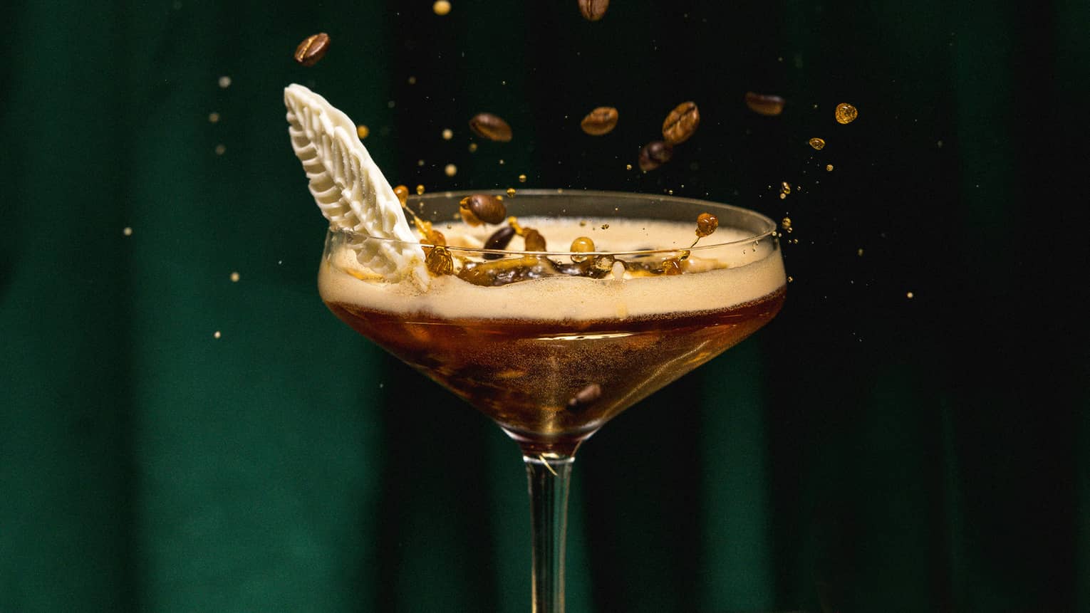 A cocktail with coffee beans as a garnish.