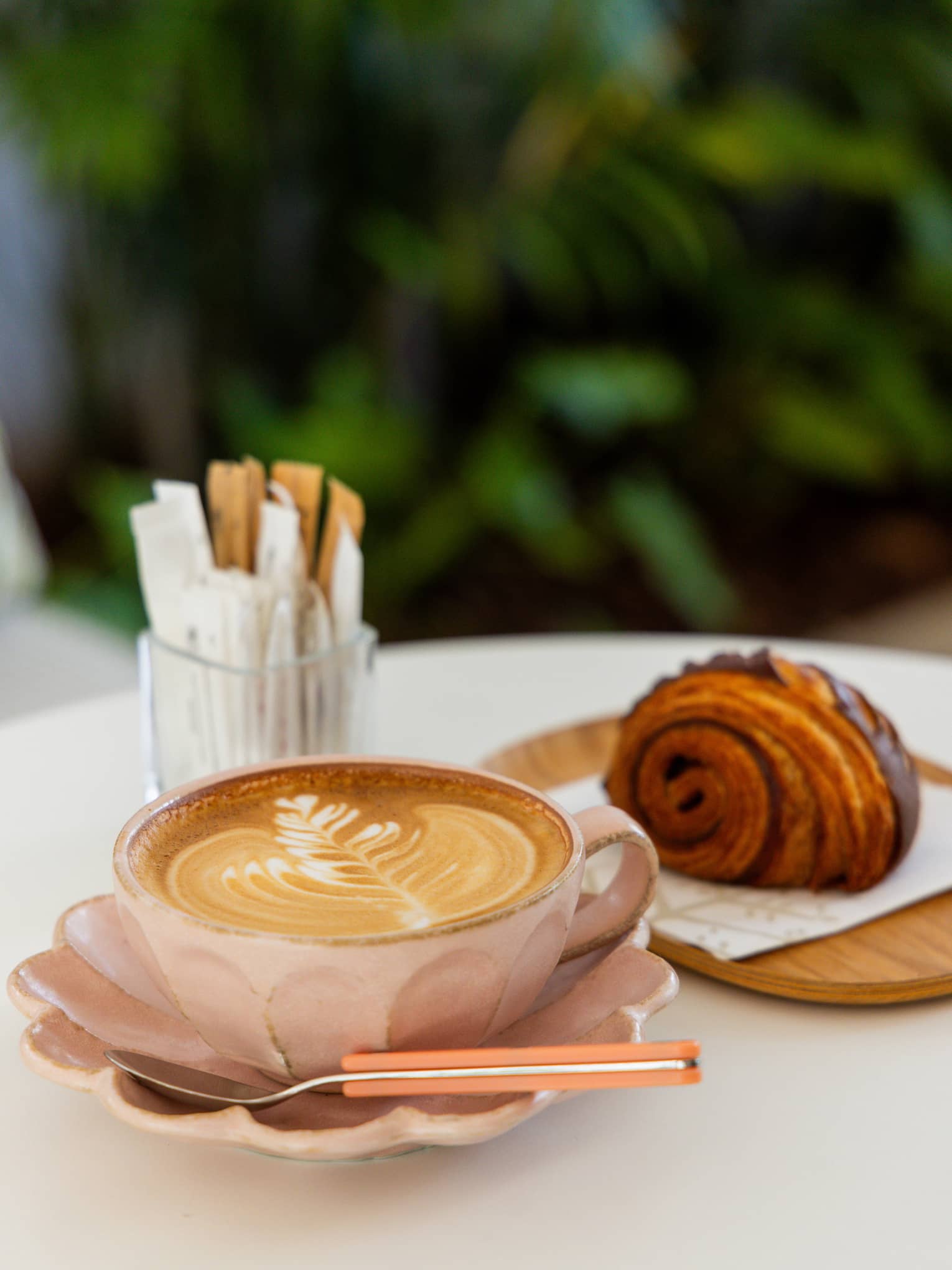 Cappuccino and croissant on an outdoor table