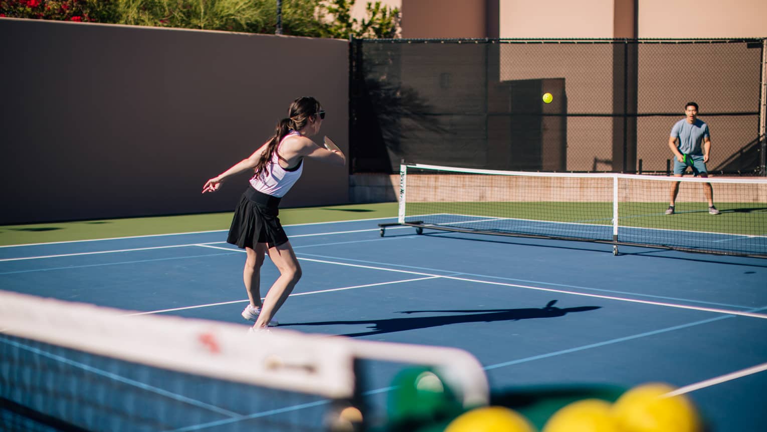 A woman and man on a tennis court.