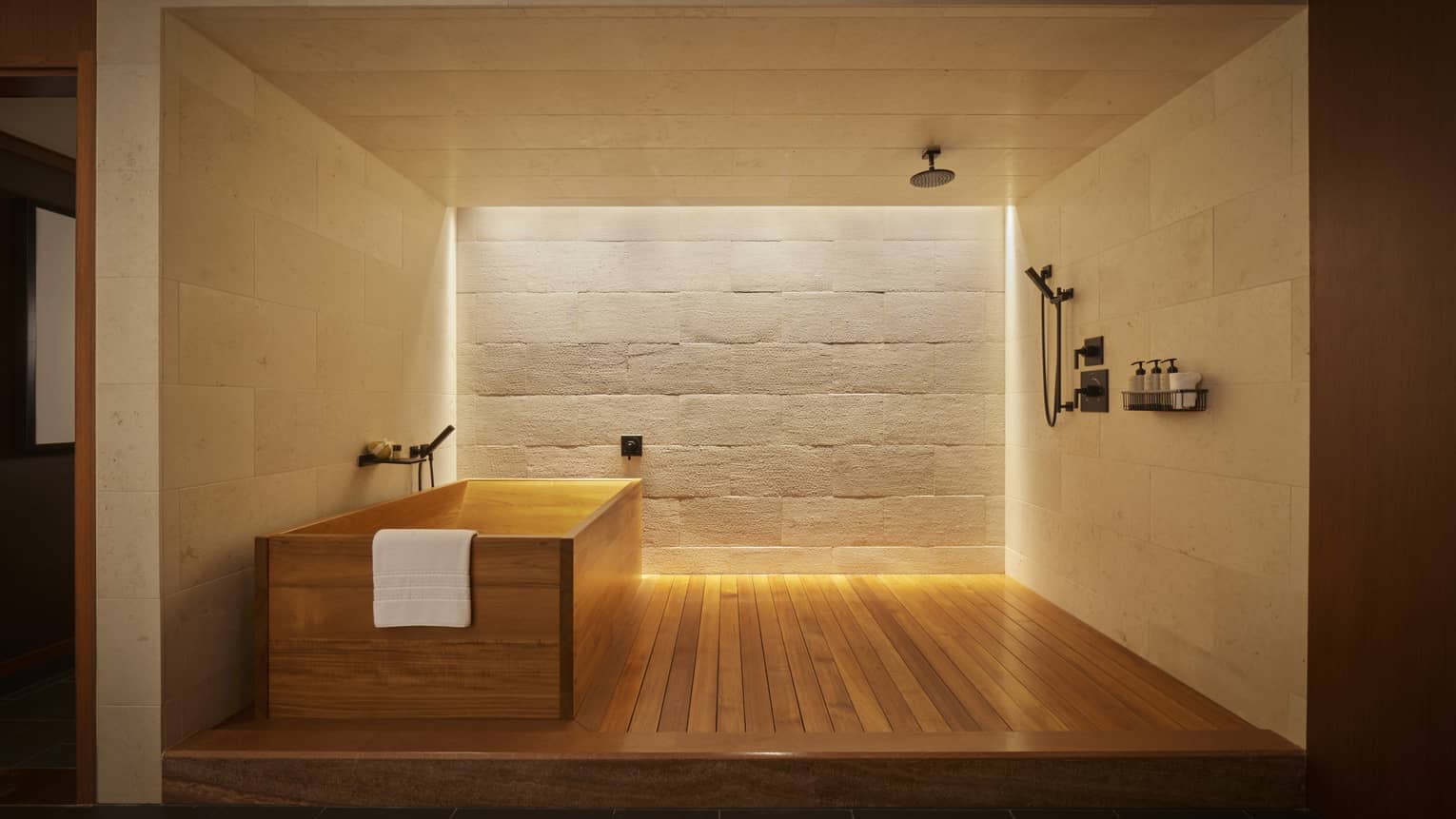 Modern bathroom with wooden floor, wooden tub, stone wall and shower