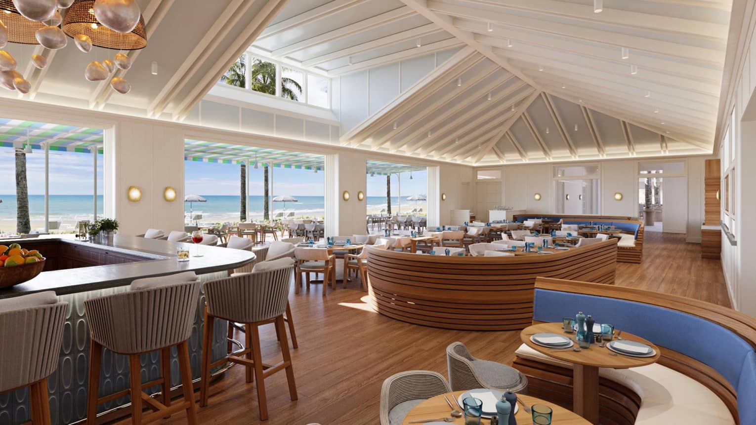 A coastal chic restaurant with vaulted ceilings and curved booths