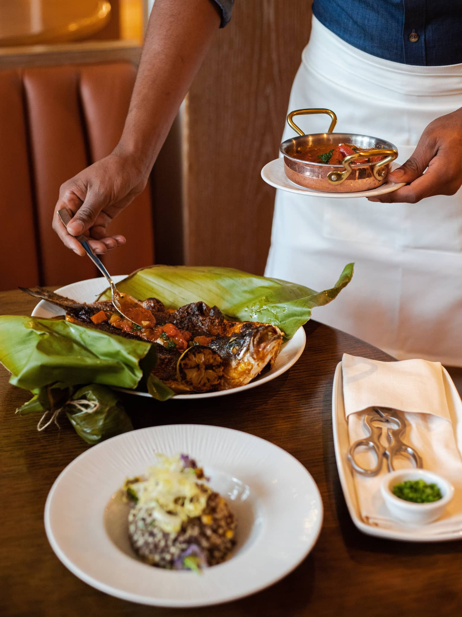 Roasted fish in a large leaf.