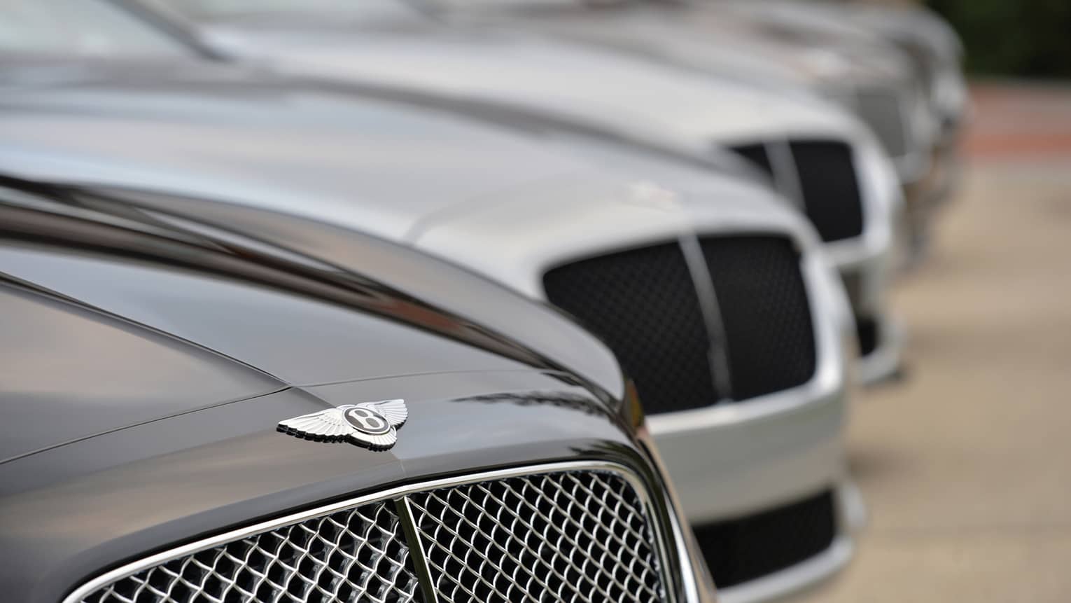 Close up of Bentley car, as part of line up of luxury cars