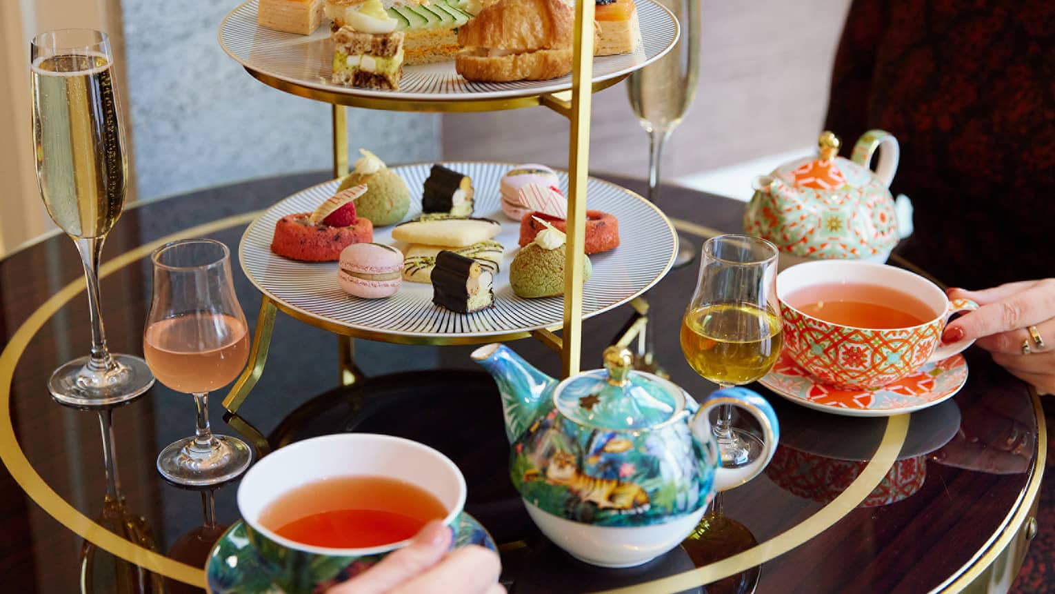 A tea set with pastries and small foods.