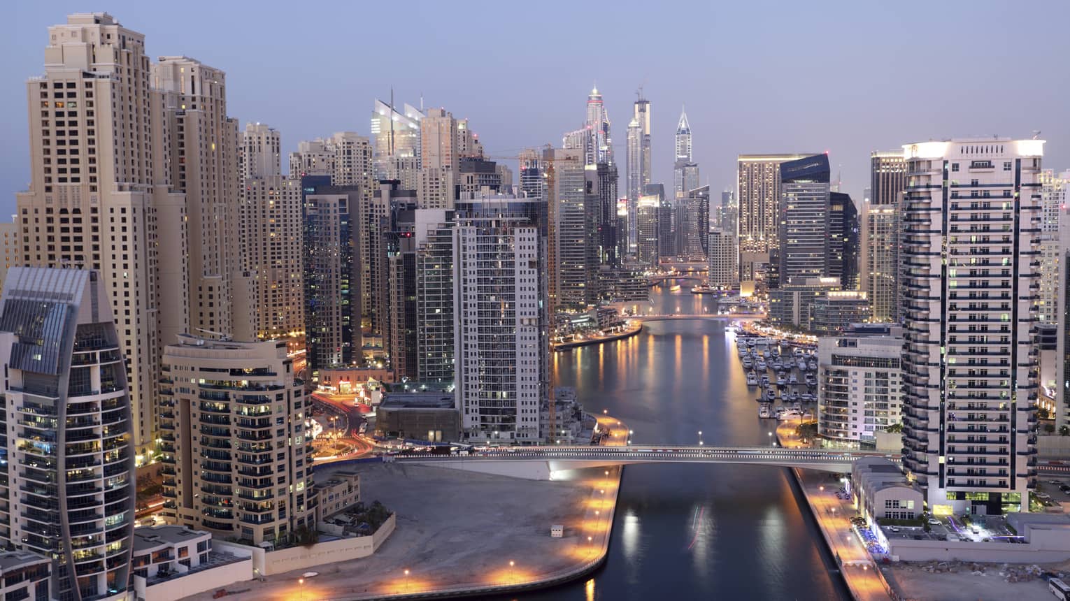 Dubai skyline buildings and marina at dusk