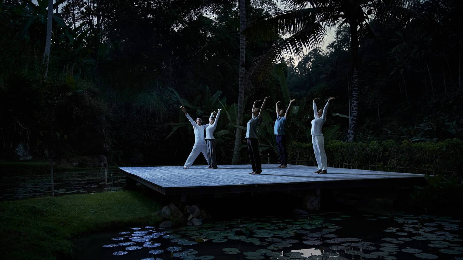 Group full moon purnama yoga near pond in Bali