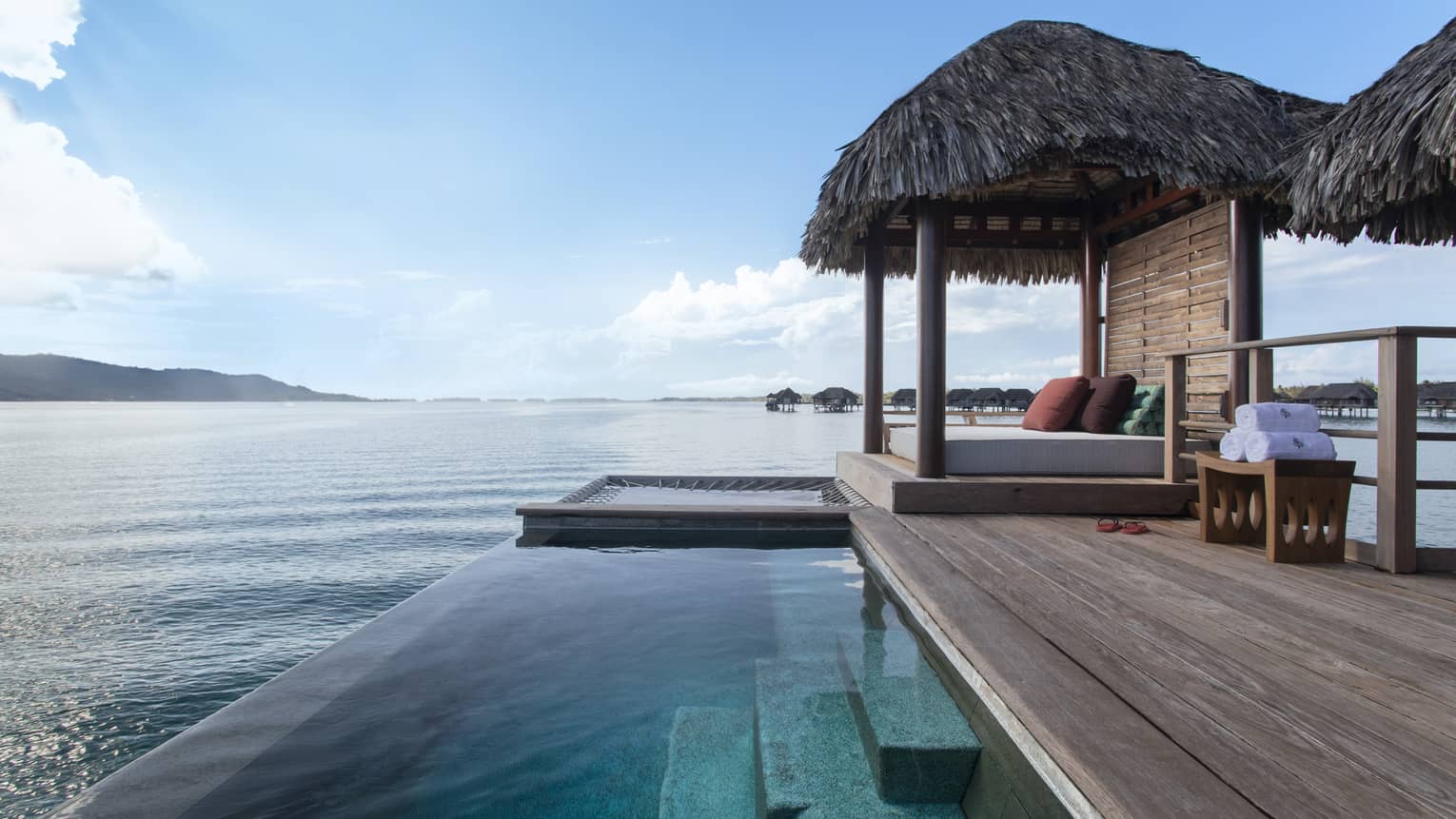 Private deck of Bungalow, with infinity pool and thatched-roof sun bed