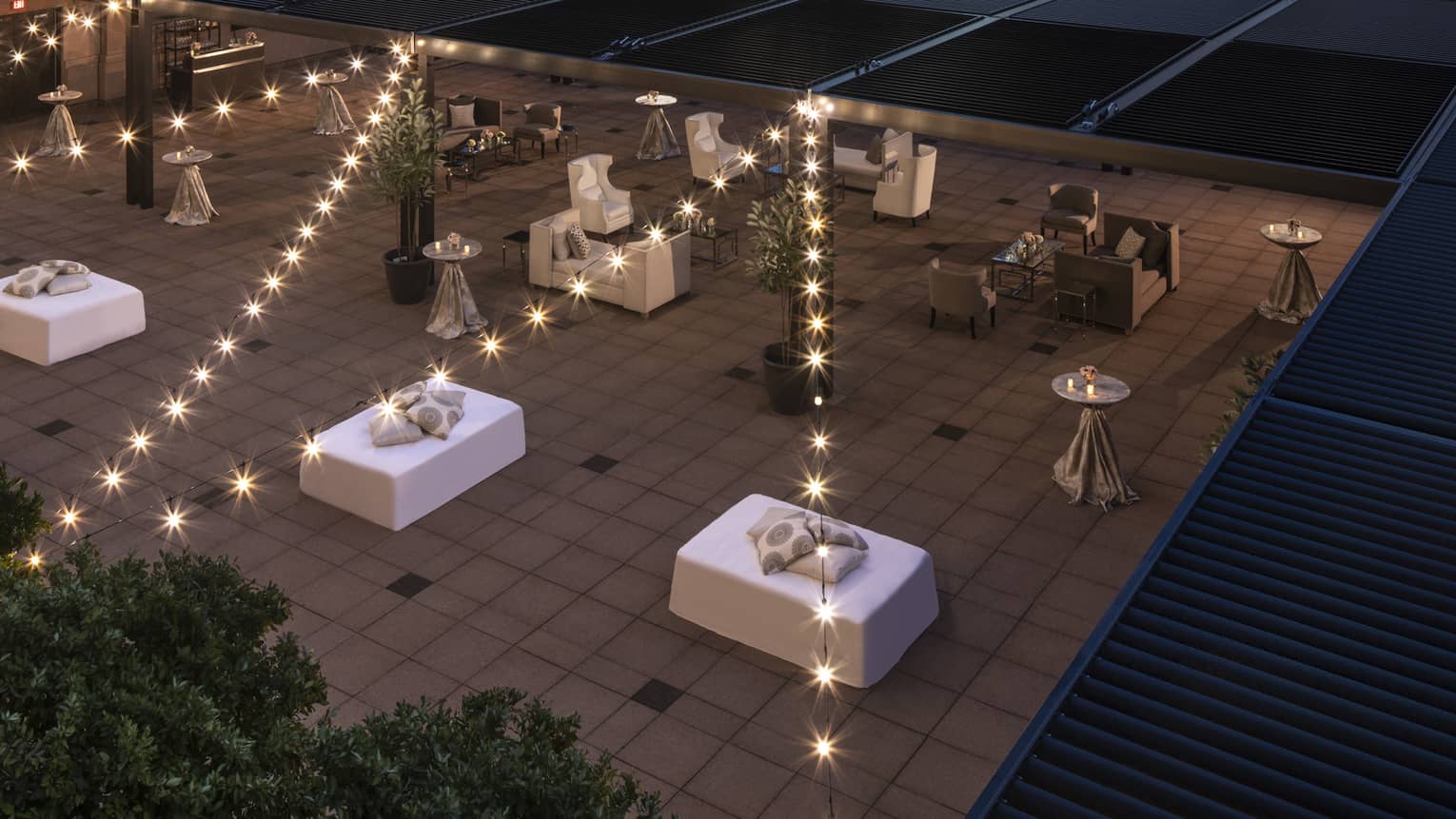 Aerial view of reception on fifth-floor Terrace under city buildings at night