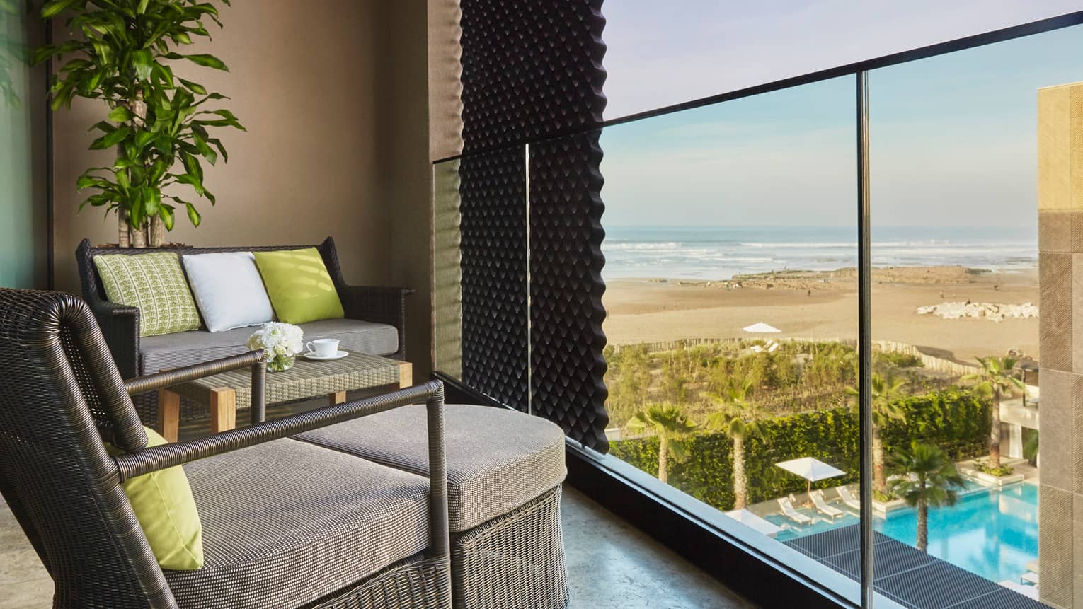 Premier Room balcony large wicker chairs with cushions, lime green accent pillows, beach views