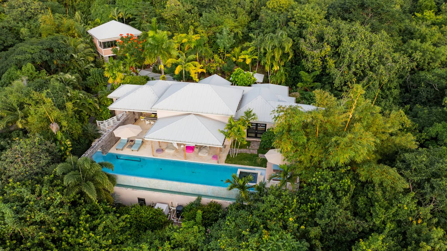 Aerial view of a residence surrounded by dense jungle
