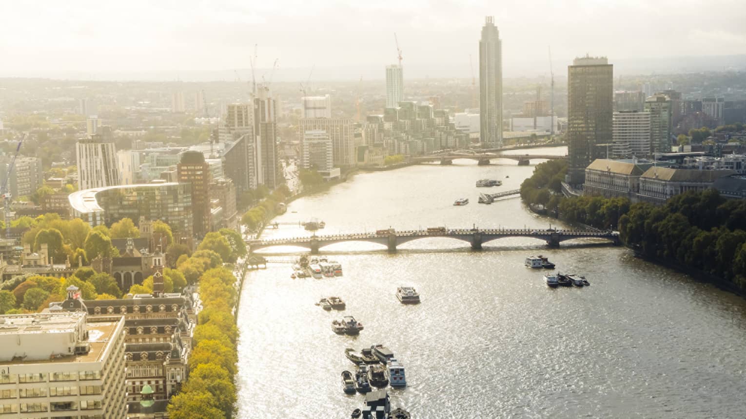 Aerial view of Thames River, London skyline on sunny day