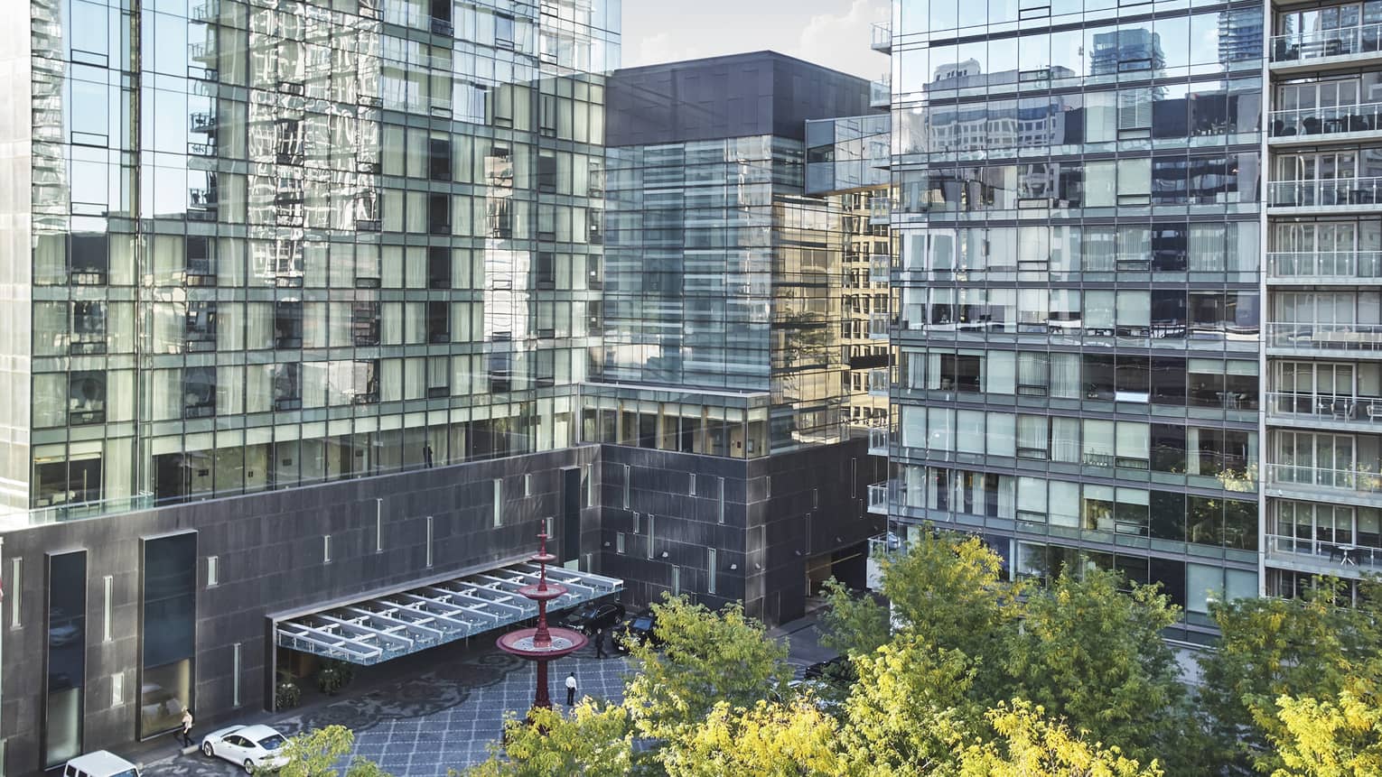 Several glass buildings standing side-by-side, overlooking a courtyard.