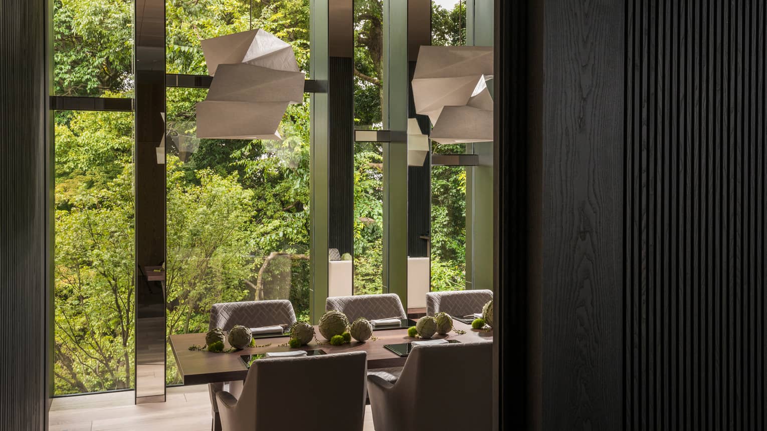 Sushi Wakon modern chandeliers over dining table by tall floor-to-ceiling window