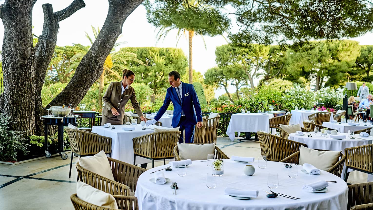 Le Cap terrace with tables covered in white tablecloths and with light-brown chairs