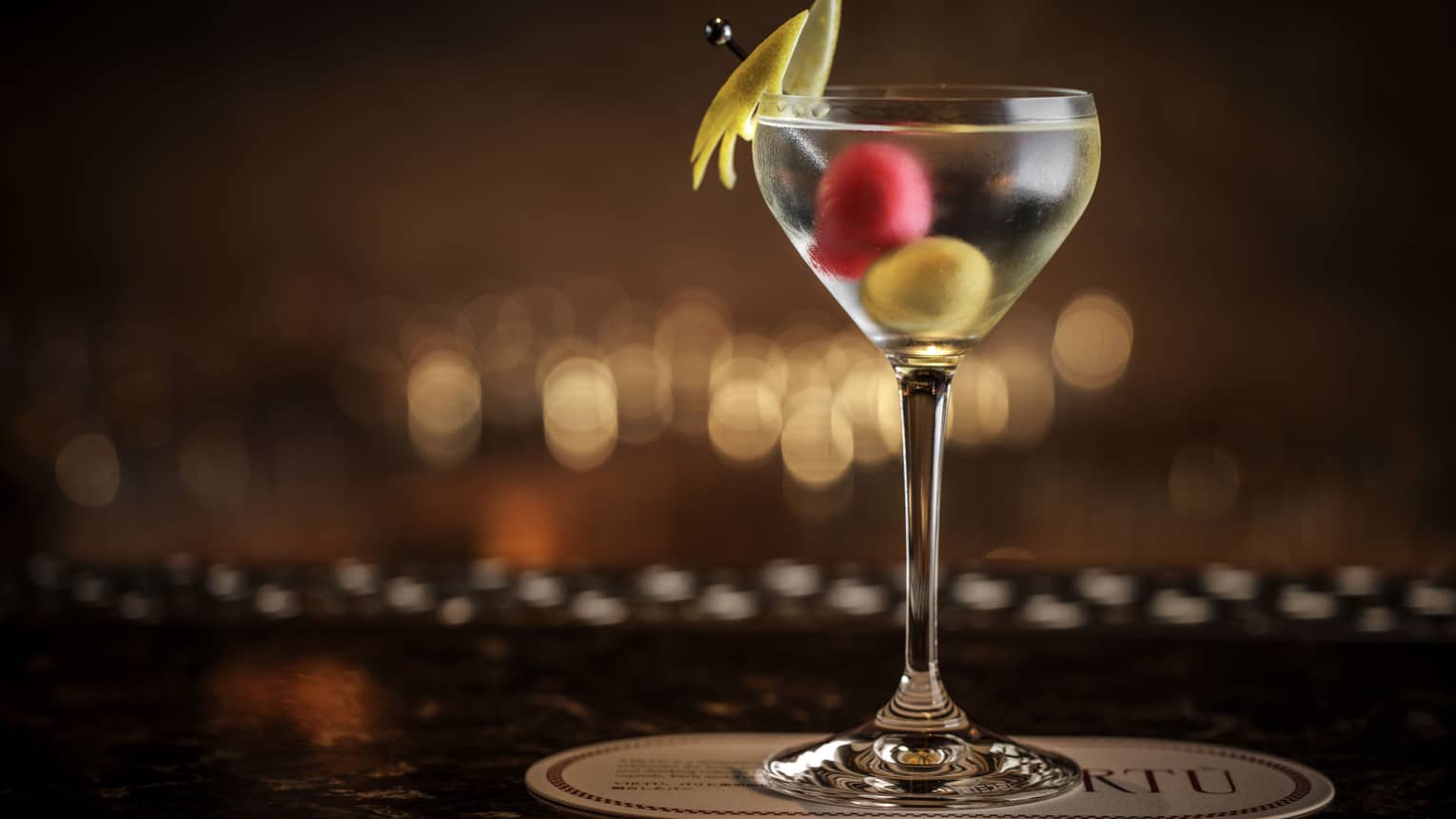Martini garnished with two olives and a spear