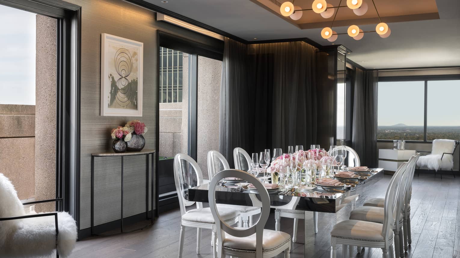 Bright, modern Penthouse boardroom private dining table under bulb lights