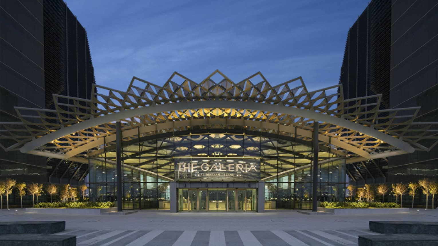 Galleria Mall entrance with sign and exterior with elaborate modern awning at dusk