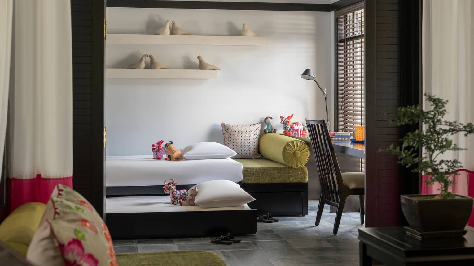 Family Villa bedroom with two children's day beds, ceramic birds on shelves