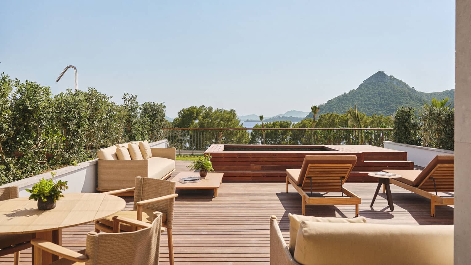 Private pine-view terrace with plunge pool, sofa, two lounge chairs and dining table at Four Seasons Resort Mallorca