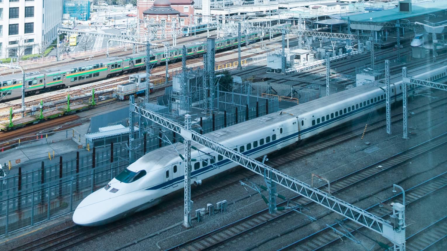 Tokyo Station view looking down at white train on railway tracks