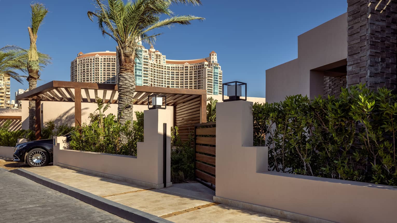 Main gate of One-Bedroom Beach Villa flanked by palm trees