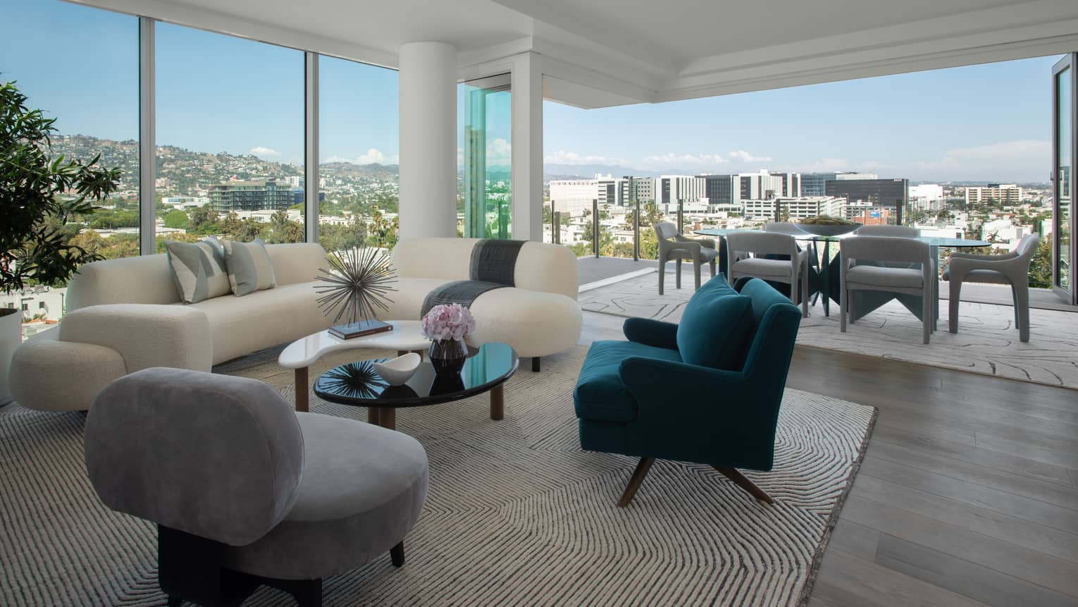 Interior view of dining and living area, with floor-to-ceiling windows and views