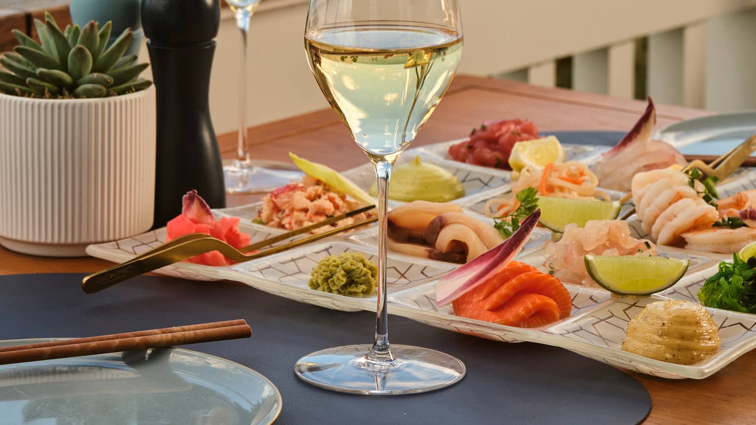 Crudo platter set on an outdoor table overlooking the beach