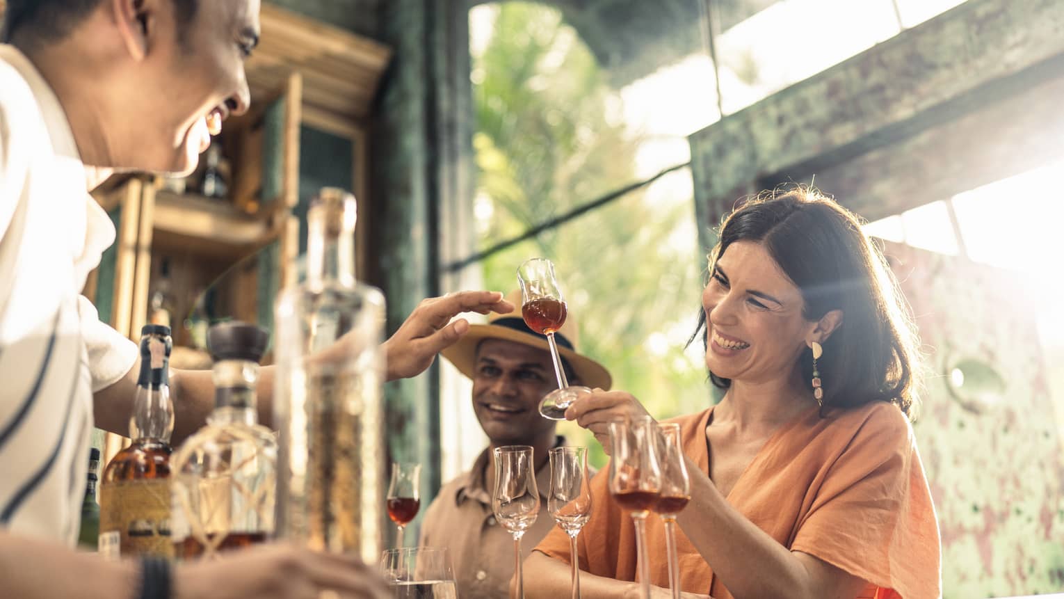 Smiling woman enjoys rum tasting at Rum Vault