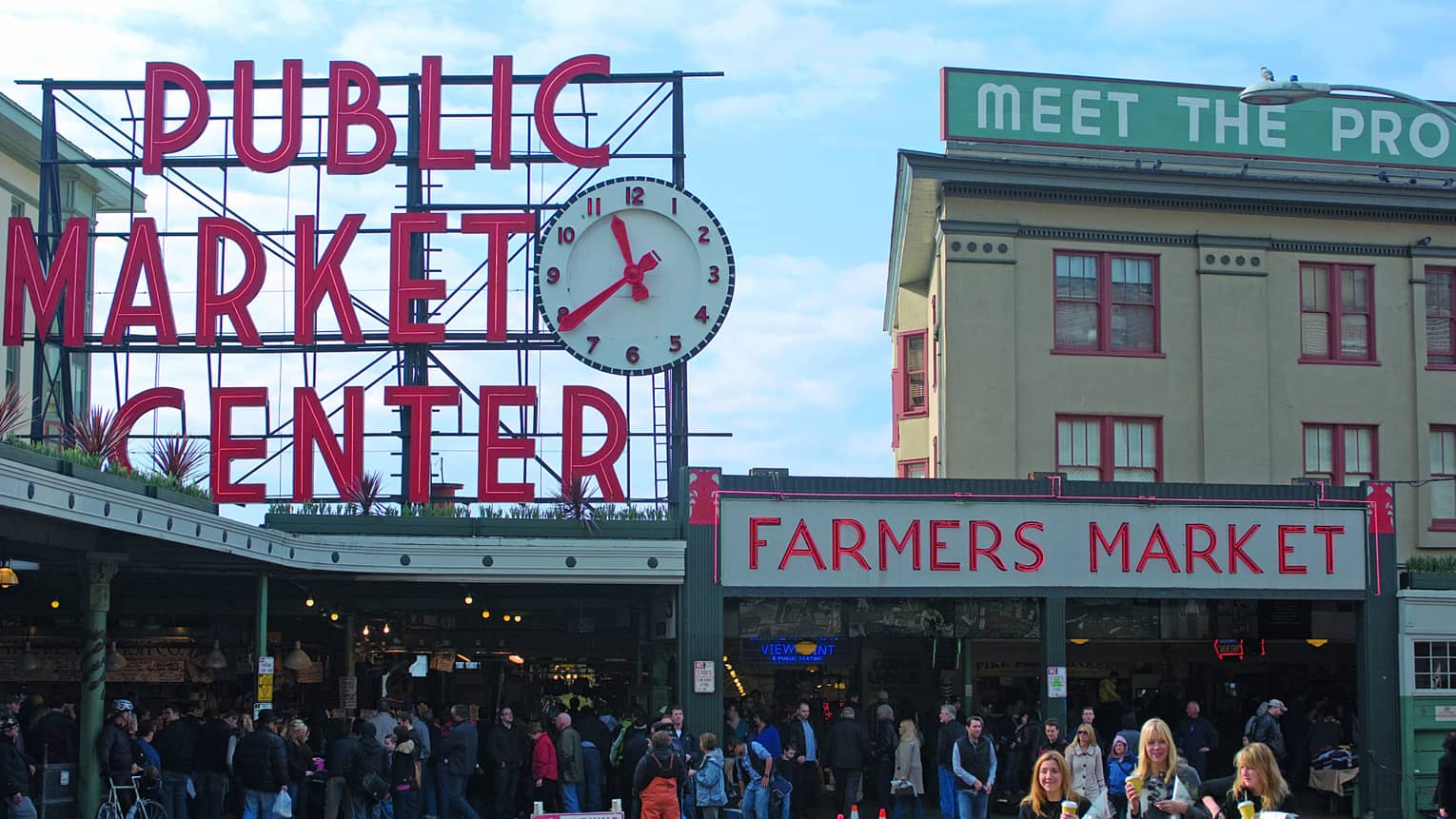 Public Market Center and Farmers Market signs over crowd along sidewalk