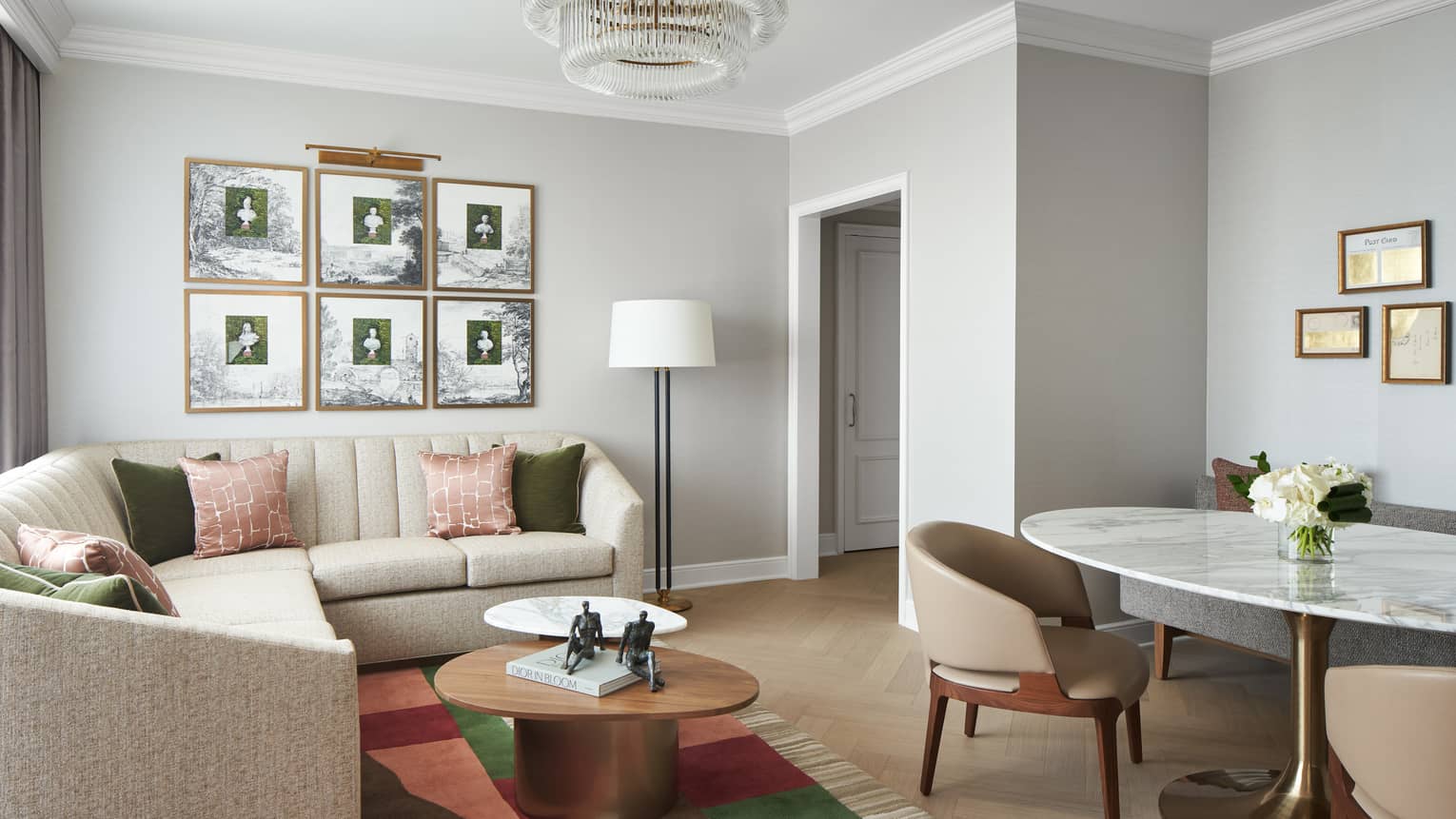 Chic living room of a Georgetown Suite, with sectional sofa and marble dining table, at Four Seasons Hotel Washington, DC