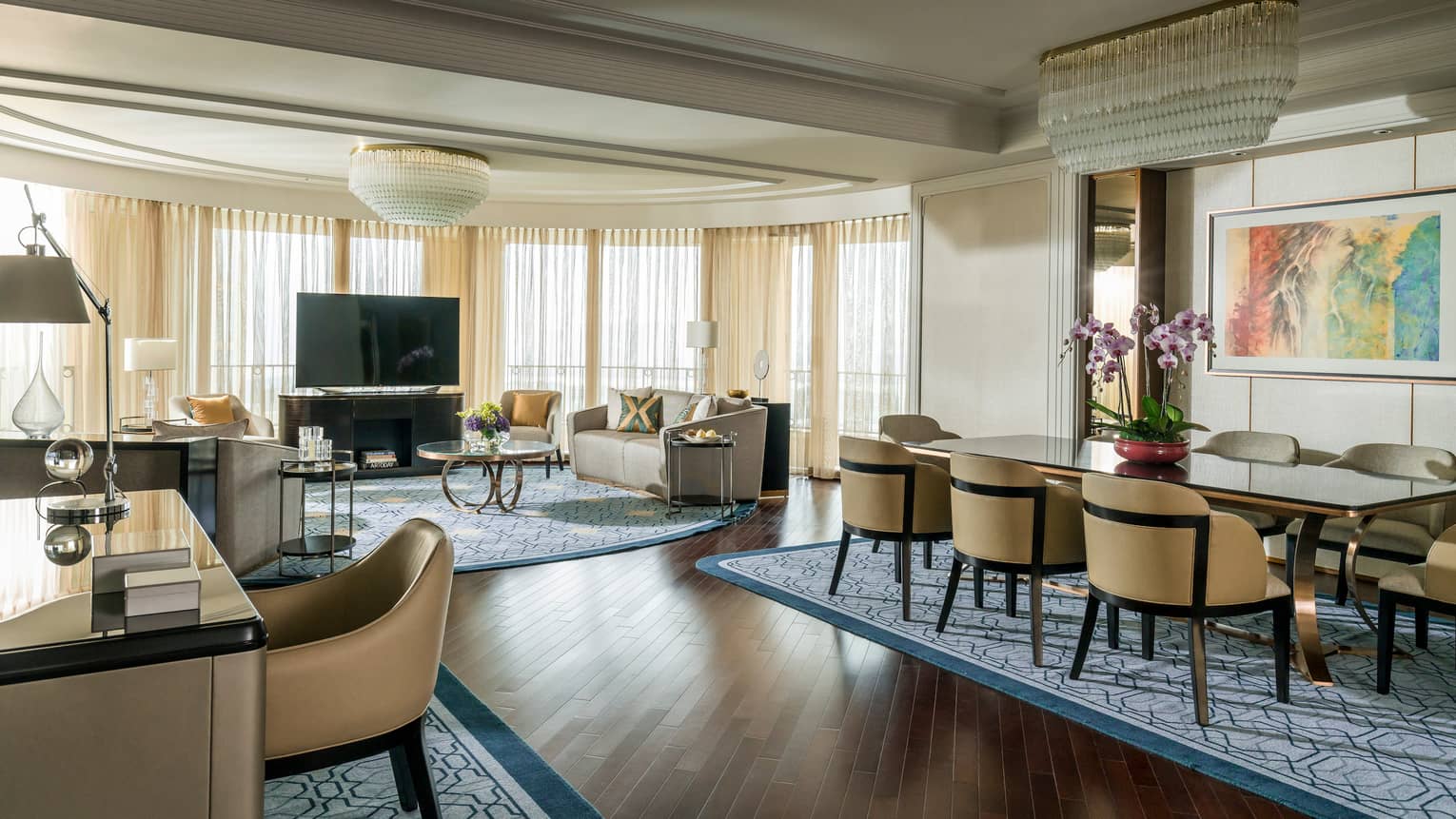 Spacious Presidential Suite desk, dining table in front of spacious living room, TV